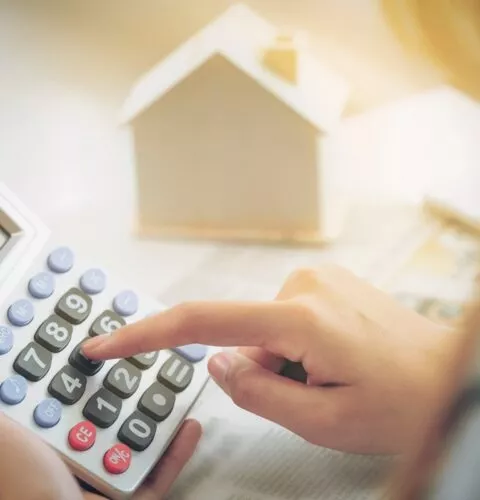 Une femme comptable ou employée de banque utilise une calculatrice.